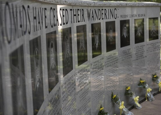 Flowers are placed along the Nomad Memorial remembrance wall for the Khobar Towers 21st Anniversary Wreath Laying Ceremony June 23, 2017, at Eglin Air Force Base, Florida. On June 25, 1996, a bomb was detonated near the Khobar Towers housing complex in Dhahran, Saudi Arabia. Nineteen Airmen were killed and more than 400 U.S. and international military and civilians were injured in the blast.  Of the 19 killed, 12 were Nomads. Each year the 33 FW holds a ceremony in remembrance of that day. (U.S. Air Force photo by Staff Sgt. Peter Thompson)