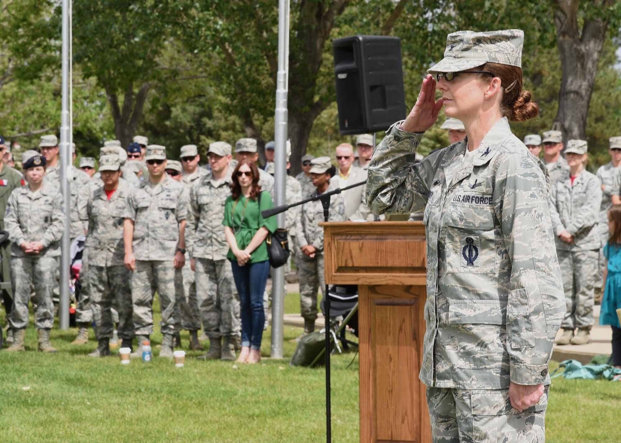 Colonel Stacy Huser, 90th Missile Wing commander, returns the first salute given to her by her wing at the change of command ceremony on the Argonne Parade Field at F.E. Warren Air Force Base, Wyo., June 23, 2017. The ceremony signified the transition of command from Col. Stephen Kravitsky to Huser. (U.S. Air Force photo by Glenn S. Robertson)