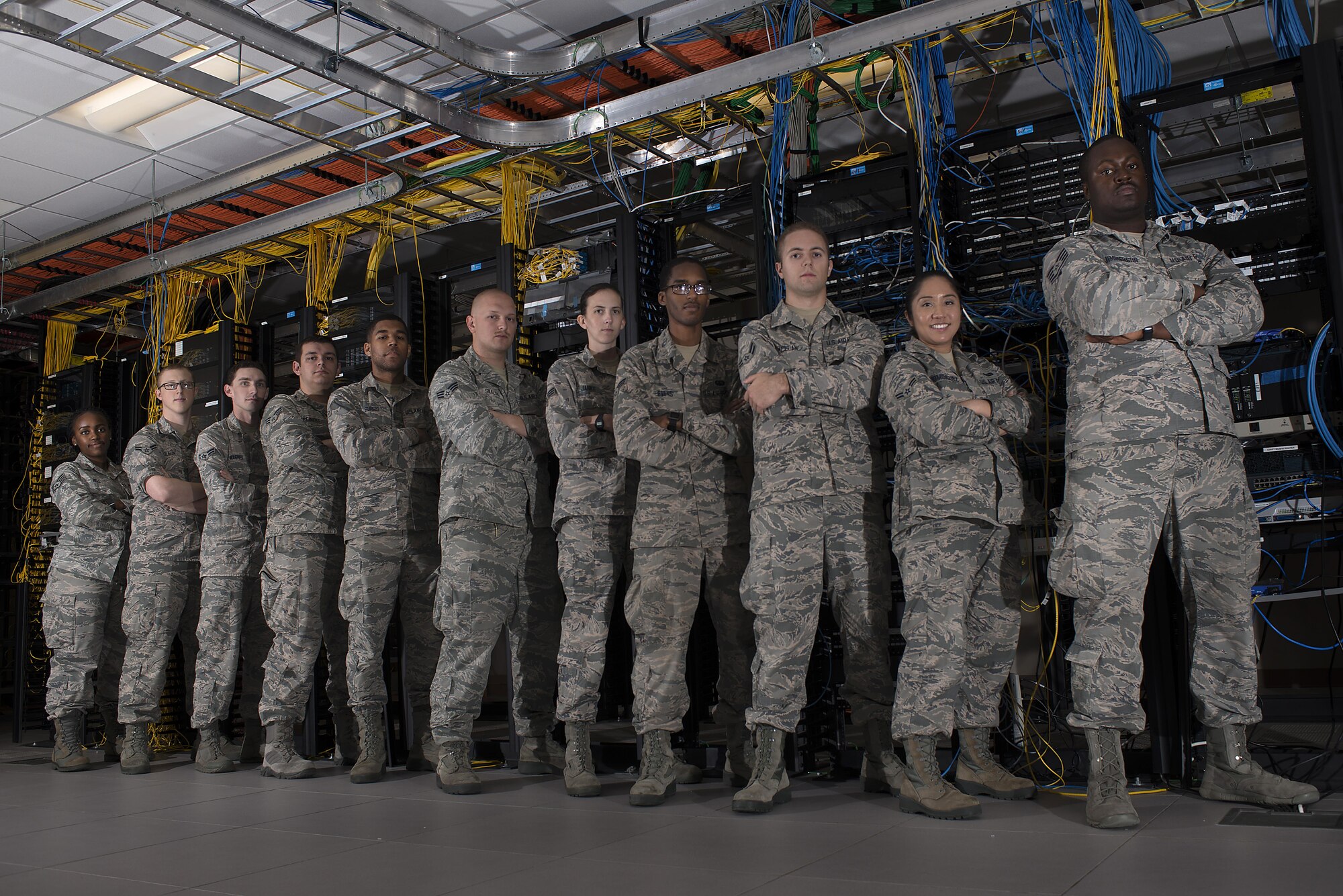 U.S. Air Force technicians assigned to the 6th Communications Squadron (CS) base infrastructure shop pause for a photo, June 15, 2017 at MacDill Air Force Base, Fla. The 6th CS is in the process of installing a new system upgrade, which drastically improves network security. (U.S. Air Force photo by Airman 1st Class Caleb Nunez)