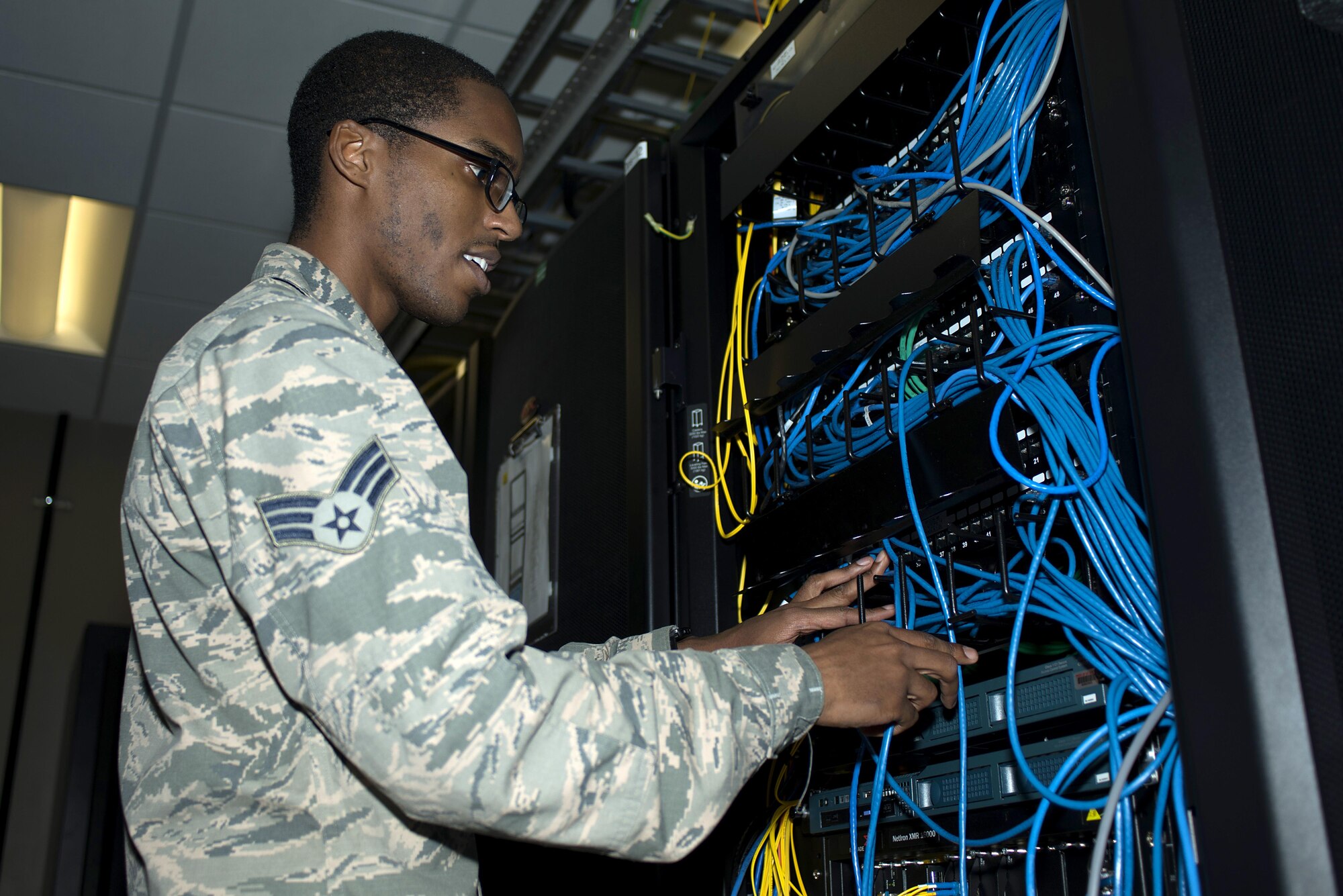 U.S. Air Force Senior Airman Christopher Evans, a cyber transport systems technician assigned to the 6th Communications Squadron, performs cable maintenance on a network server as part of a system upgrade, June 15, 2017 at MacDill Air Force Base, Fla. The new system upgrade is scheduled to be completed by late June. (U.S. Air Force photo by Airman 1st Class Caleb Nunez)