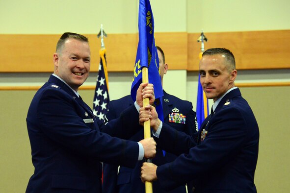 Maj. Arron Tulick, right, accepts command of the 741st Maintenance Squadron from Col. Kenneth Speidel, 341st Maintenance Group commander, June 23, at Malmstrom Air Force Base, Mont. Master Sgt. Justin Tayler, 741st MXS first sergeant, looks on. (U.S. Air Force photo/Senior Airman Magen M. Reeves)