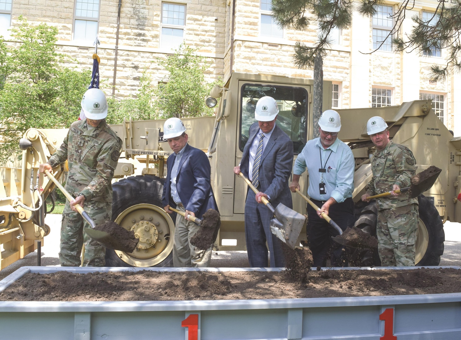 LEFT TO RIGHT: Command Sgt. Maj. James Collins, United States Army Garrison Fort Riley; Albert Marin, programs director for the Huntsville Engineering and Support Center; Joseph Cvetas, executive vice president for Southland Industries; Sandy Walker, Fort Riley Public Works; Col. John D. Lawrence, Fort Riley garrison commander, turn ceremonial dirt during a groundbreaking ceremony June 13 at Fort Riley. The ceremony highlighted the award of an energy savings performance contract to Southland Energy and commemorated the start of the construction phase.
