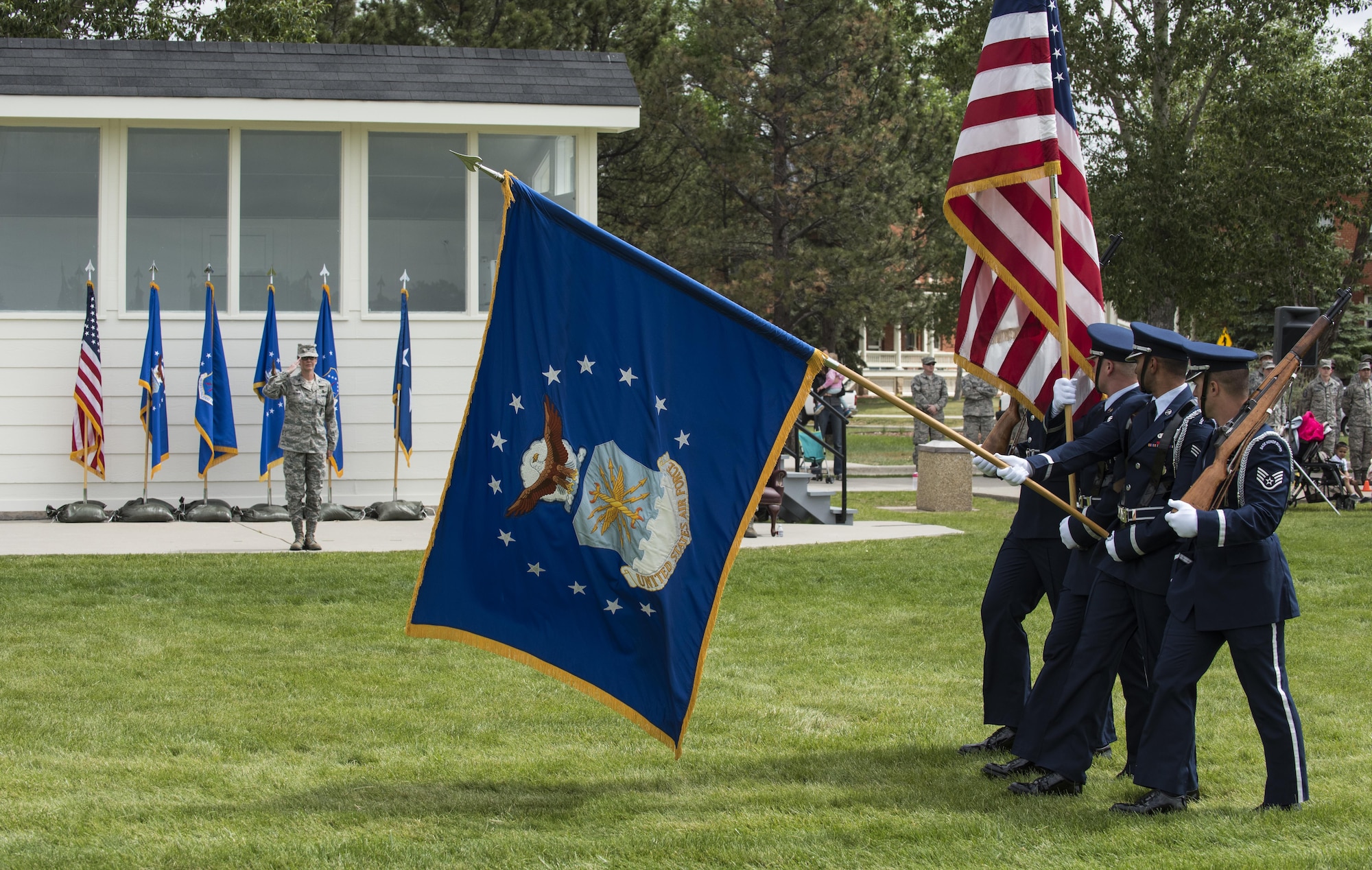 Colonel Stacy Huser, 90th Missile Wing commander, renders a salute as the F.E. Warren Air Force Base honor guard march pass during the 90th MW change of command ceremony pass in review on the Argonne Parade Field at F.E. Warren Air Force Base, Wyo., June 23, 2017. A formal parade is a long-standing military tradition that began as a way for a newly-assigned commander to inspect their troops. The change of command ceremony signified the transition of command from Col. Stephen Kravitsky to Huser. (U.S. Air Force photo by Staff Sgt. Christopher Ruano)