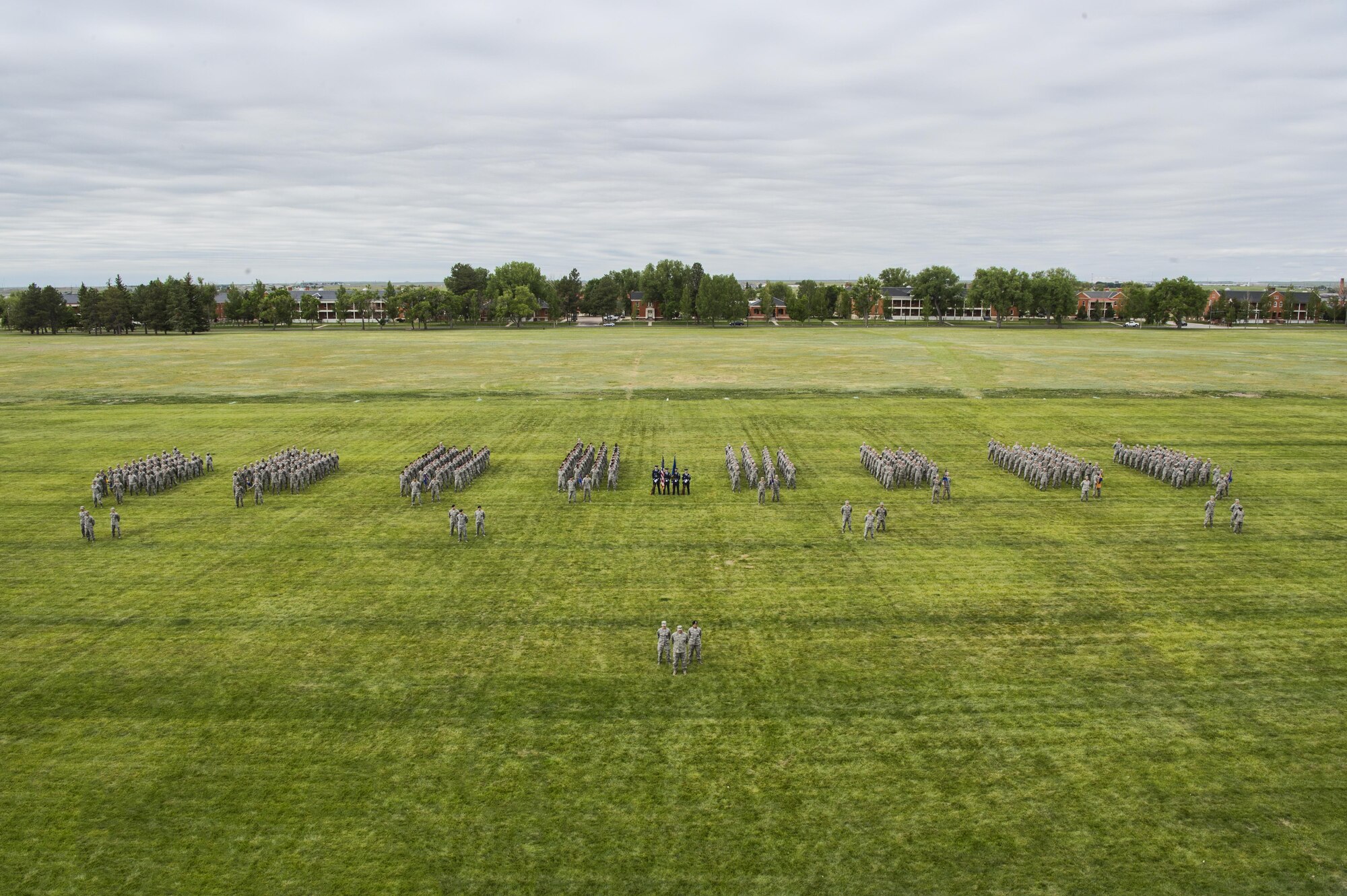 Airmen of the 90th Missile Wing stand in formation during the 90th MW change of command ceremony on the Argonne Parade Field at F.E. Warren Air Force Base, Wyo., June 23, 2017. Members from all four groups within the wing participated in the formation. The change of command ceremony signified the transition of command from Col. Stephen Kravitsky to Col. Stacy Huser. (U.S. Air Force photo by Staff Sgt. Christopher Ruano)