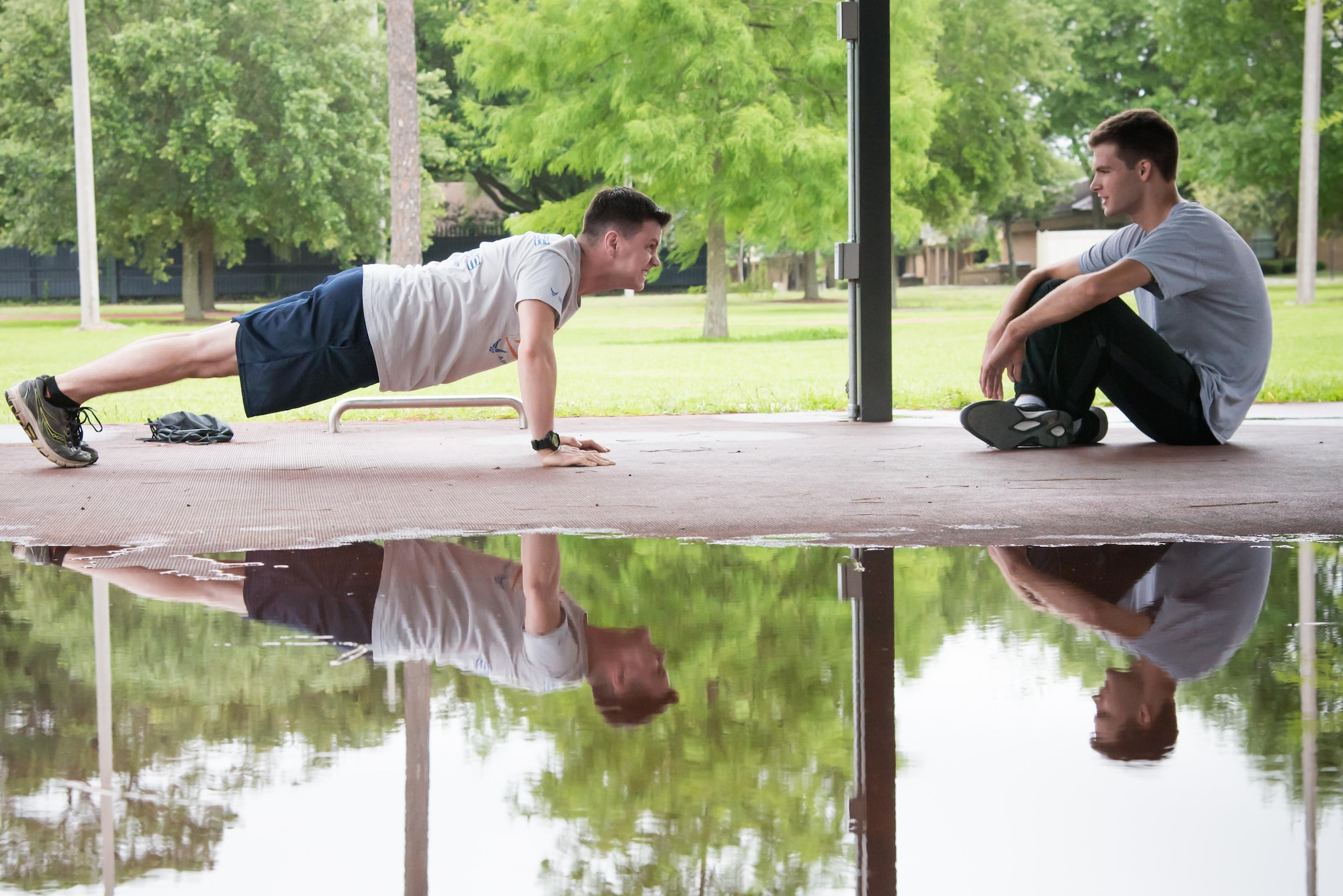 Chris Geter and Jonathan Green, 403rd Developmental and Training Flight trainees, take turns practicing pushups during a physical training session June 3, 2017 at Keesler Air Force Base, Mississippi.(U.S. Air Force photo/Staff Sgt. Heather Heiney)