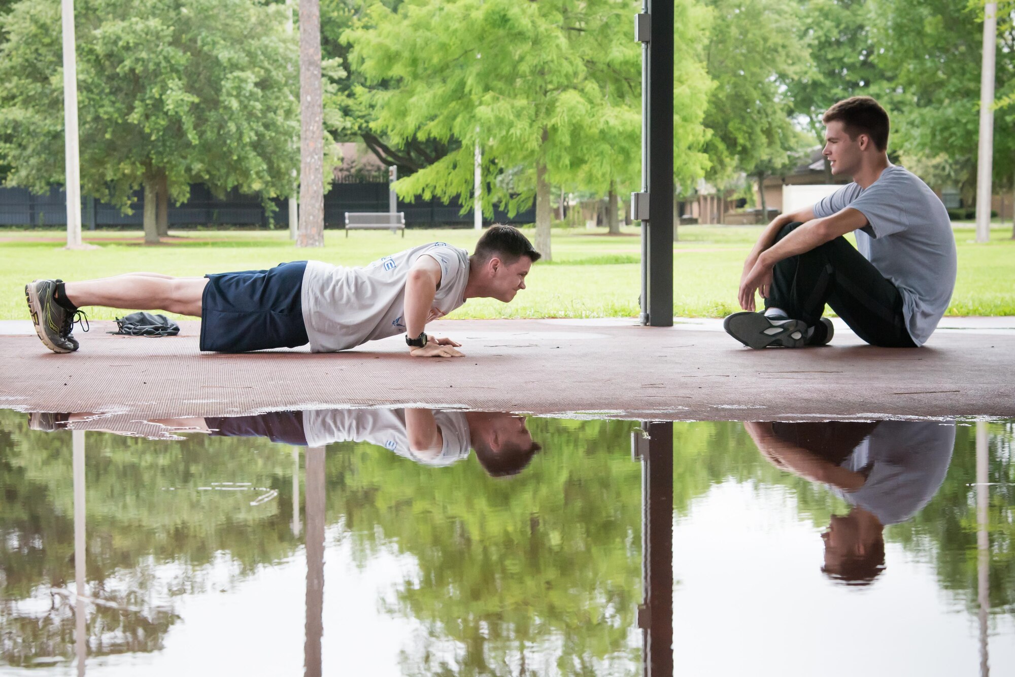 Chris Geter and Jonathan Green, 403rd Developmental and Training Flight trainees, take turns practicing pushups during a physical training session June 3, 2017 at Keesler Air Force Base, Mississippi.(U.S. Air Force photo/Staff Sgt. Heather Heiney)