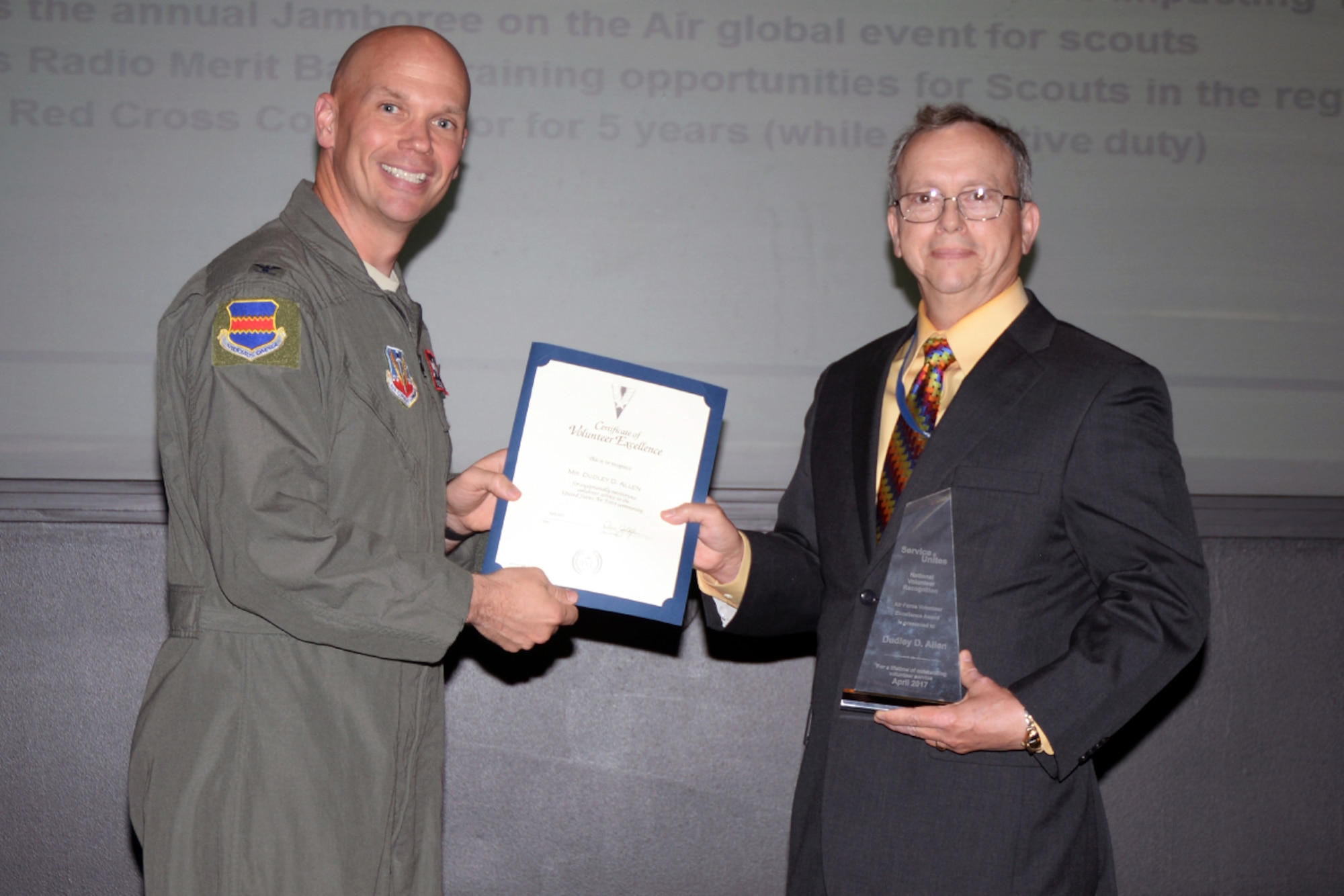Col. Michael Manion, 55th Wing commander, presents Dudley Allen, 55th Force Support Squadron management analyst, with the 2016 Air Force Volunteer Excellence Award during the 55th Wing staff meeting June 12 at the base conference center.