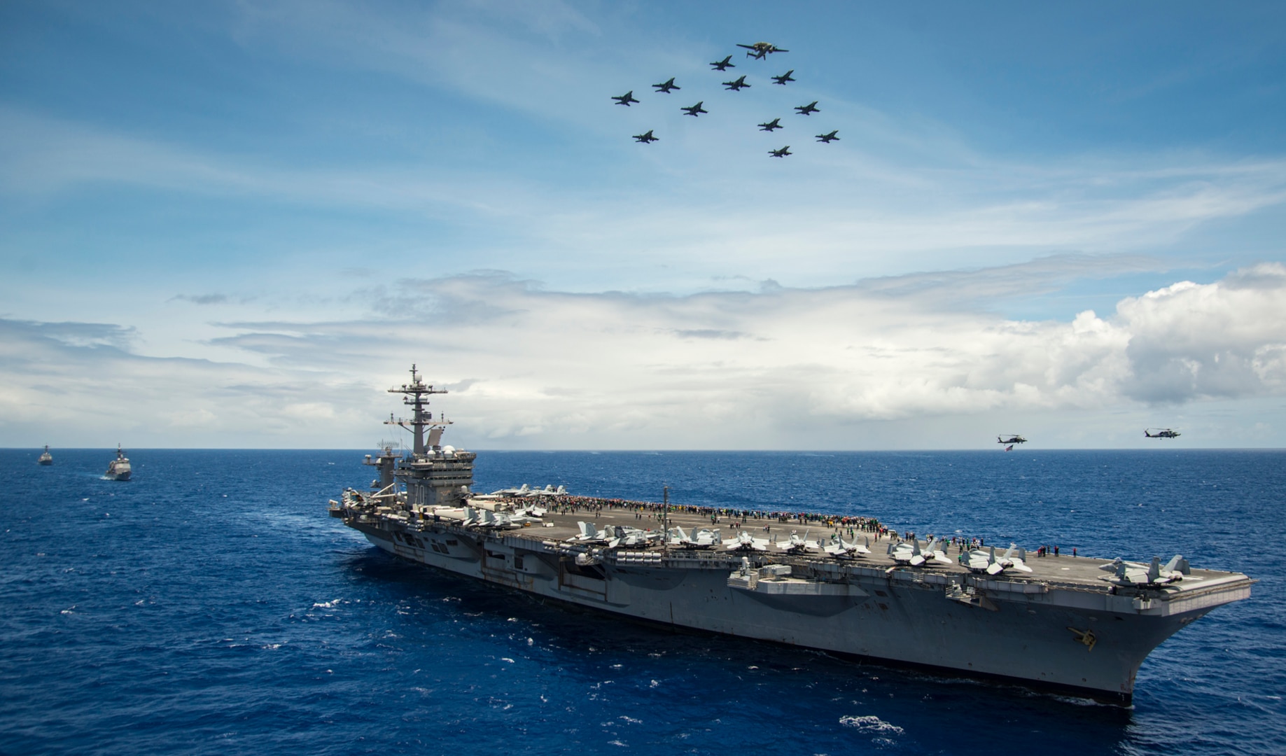 Aircraft assigned to Carrier Air Wing (CVW) 2 fly above the Nimitz-class aircraft carrier USS Carl Vinson (CVN 70) as part of an air power demonstration during a Tiger Cruise, June 18, 2017. Tiger Cruise allows friends and family members of Sailors to embark the ship to experience U.S. Navy life at sea. The U.S. Navy has patrolled the Indo-Asia-Pacific routinely for more than 70 years promoting regional peace and security. 
