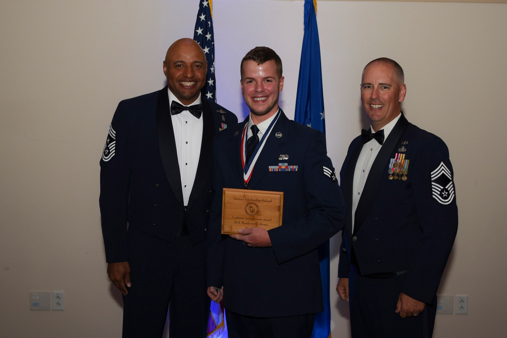 Senior Airman Matthew C. Bruce, 460th Space Communication Squadron client system technician, receives the Academic Achievement Award during Airman Leadership School Class 17E graduation June 22, 2017, on Buckley Air Force Base, Colo. This award was earned by graduating with the highest overall grade at the end of the six-week class. (U.S. Air Force photo by Airman 1st Class Holden S. Faul/ released)
