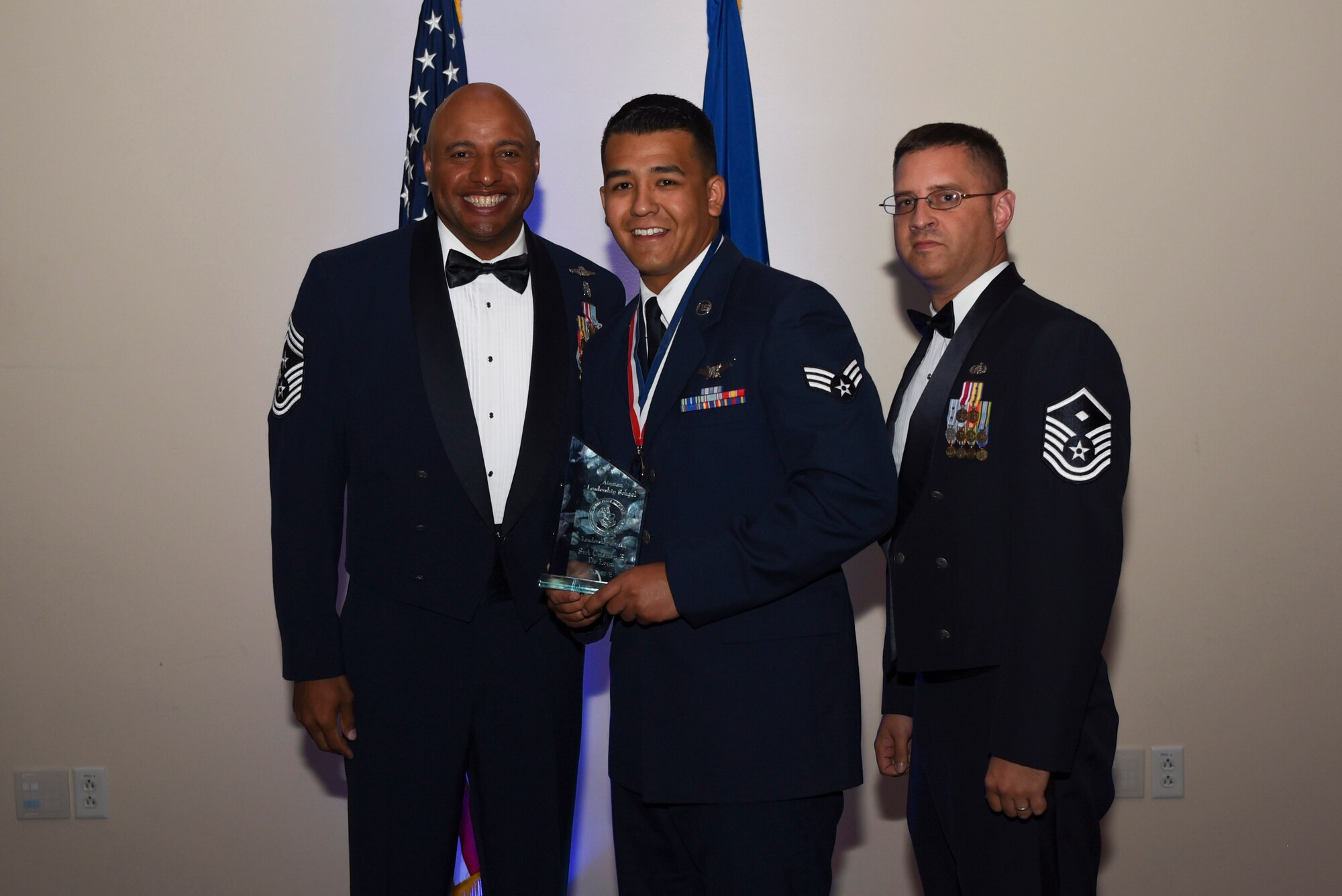 Senior Airman Cristian E. De Leon, 460th Operation Support Squadron staff instructor, receives the Commandant Leadership Award during Airman Leadership School Class 17E graduation June 22, 2017, on Buckley Air Force Base, Colo. This award was earned by displaying all the characteristics of an effective leader. (U.S. Air Force photo by Airman 1st Class Holden S. Faul/ released)