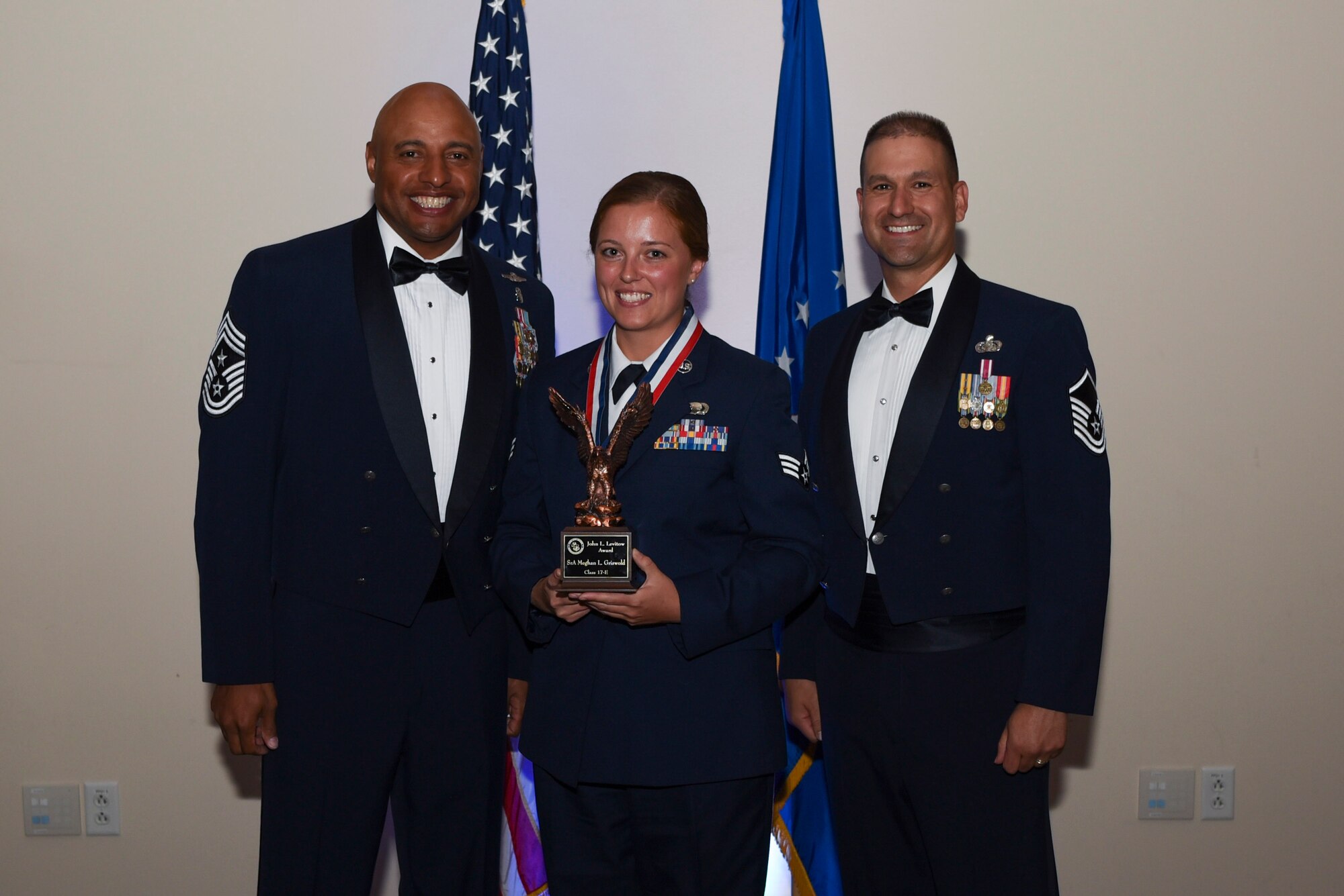 Senior Airman Meghan L. Griswold, 460th Operations Group intelligence analyst, receives the John L. Levitow Award during Airman Leadership School Class 17E graduation June 22, 2017, on Buckley Air Force Base, Colo. The John L. Levitow Award is the highest award presented at ALS, and is presented to the student who demonstrated the most outstanding leadership and scholastic qualities. (U.S. Air Force photo by Airman 1st Class Holden S. Faul/ released)