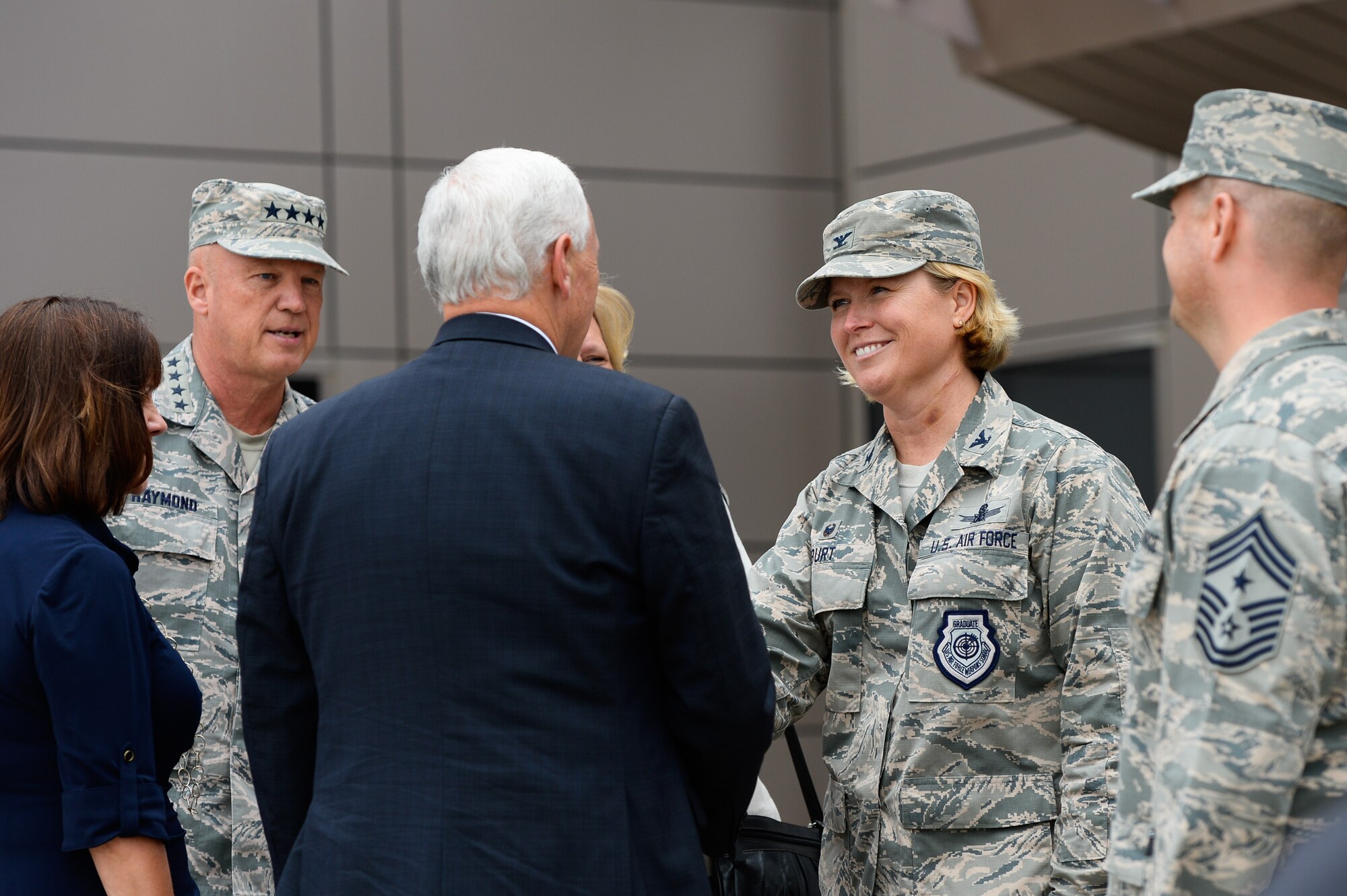Vice President Mike Pence shakes hands with Col. Deanna Burt, 50th Space Wing commander while Gen. John Raymond, Air Force Space Command commander, looks on during his visit to the 50th Space Wing visit at Schriever Air Force Base, Colo., Friday, June 22, 2017. Pence also visited with airmen during a luncheon and witnessed 2nd Space Operation’s Global Positioning System command and control functions. (U.S. Air Force photo/Christopher DeWitt)