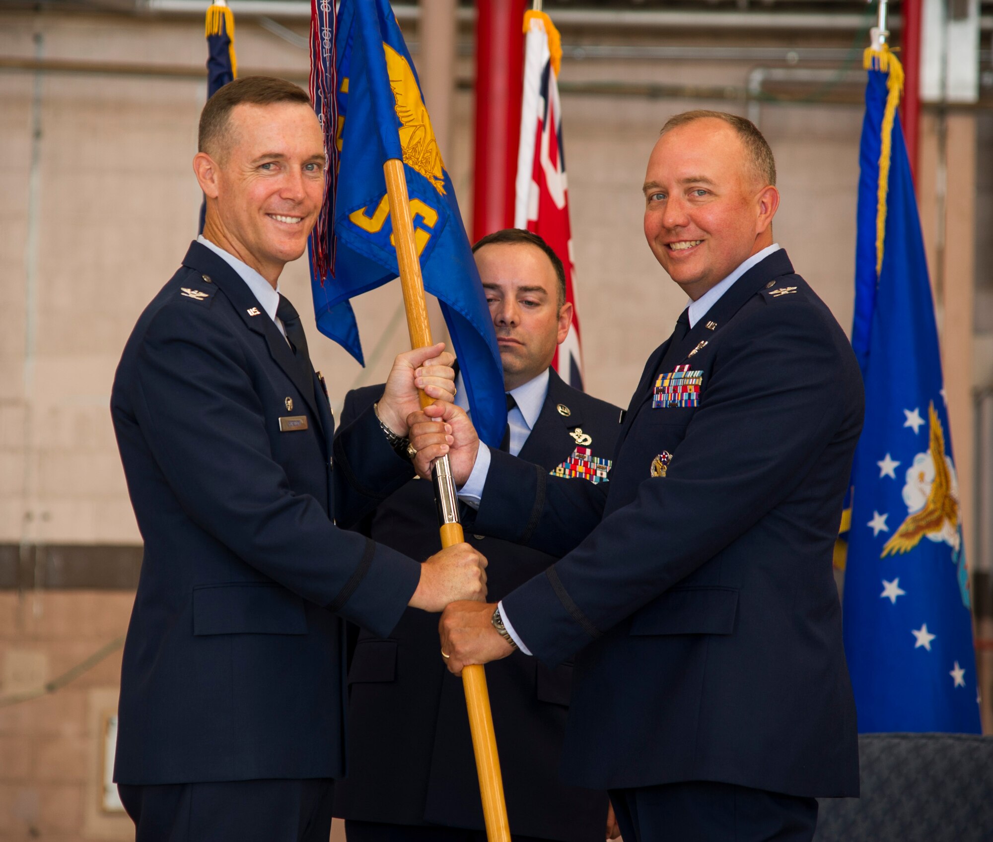 Col. Kevin Gordon, 15th Wing commander, passes the group flag to Col. Jason King, 15th Operations Group commander, during the 15th Operations Group Change of Command Ceremony, Joint Base Pearl Harbor-Hickam, Hawaii, June 22, 2017. The 15th Operations Group oversees operations at the largest joint-use airflield in the U.S., executes global combat and peace time operations, and provides executive airlift for senior military leaders.  (U.S. photo by Tech. Sgt. Heather Redman)
