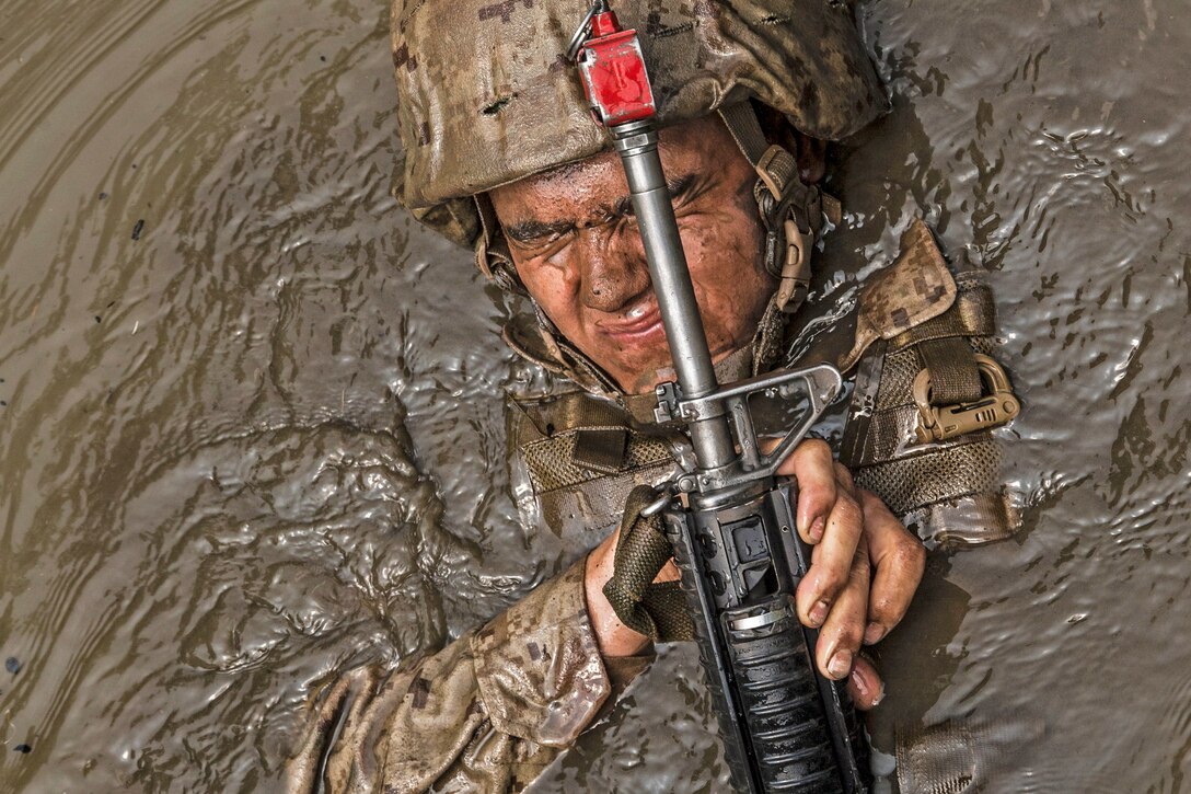 A Marine participates in an obstacle, endurance and combat course at the Officer Candidate School, Marine Corps Base Quantico, Va., June 14, 2017. Candidates must go through three months of intensive training to evaluate and screen for the leadership, moral, mental and physical qualities required for commissioning as an officer. Marine Corps photo by Lance Cpl. Cristian L. Ricardo