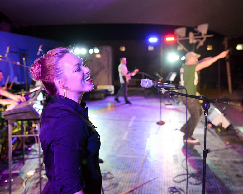 U.S. Air Force Airman 1st Class Anneke Bentley, left foreground, and Staff Sgt. Denver Murphy, vocalists assigned to the Air Force Central Command Band, sing during a concert at Al Udeid, Air Force Base, Qatar, May 26, 2017. The AFCENT Band, stationed at Al Udeid, travels throughout the Central Command Area of Responsibility in support of building partnerships, boosting morale, and providing diplomacy and outreach to host nation communities. (U.S. Air Force photo by Tech. Sgt. Bradly A. Schneider/Released)