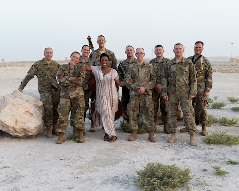 Members of the Air Forces Central Command Band pose for a photograph with Melinda Doolittle, an accomplished vocalist and top finisher on American Idol, following a practice session held at an outside venue in preparation for a concert at Al Udeid Air Base, Qatar, May 25, 2017. The AFCENT Band, stationed at Al Udeid, travels throughout the Central Command Area of Responsibility in support of building partnerships, boosting morale, and providing diplomacy and outreach to host nation communities. (U.S. Air Force photo by Tech. Sgt. Bradly A. Schneider/Released)