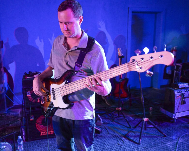 U.S. Air Force Tech. Sgt. Joshua Holdridge, Non-Commissioned Officer in Charge and bassist assigned to the Air Force Central Command Band, plays the base during a concert at Al Udeid, Air Force Base, Qatar, May 26, 2017. The AFCENT Band, stationed at Al Udeid, travels throughout the Central Command Area of Responsibility in support of building partnerships, boosting morale, and providing diplomacy and outreach to host nation communities. (U.S. Air Force photo by Tech. Sgt. Bradly A. Schneider/Released)