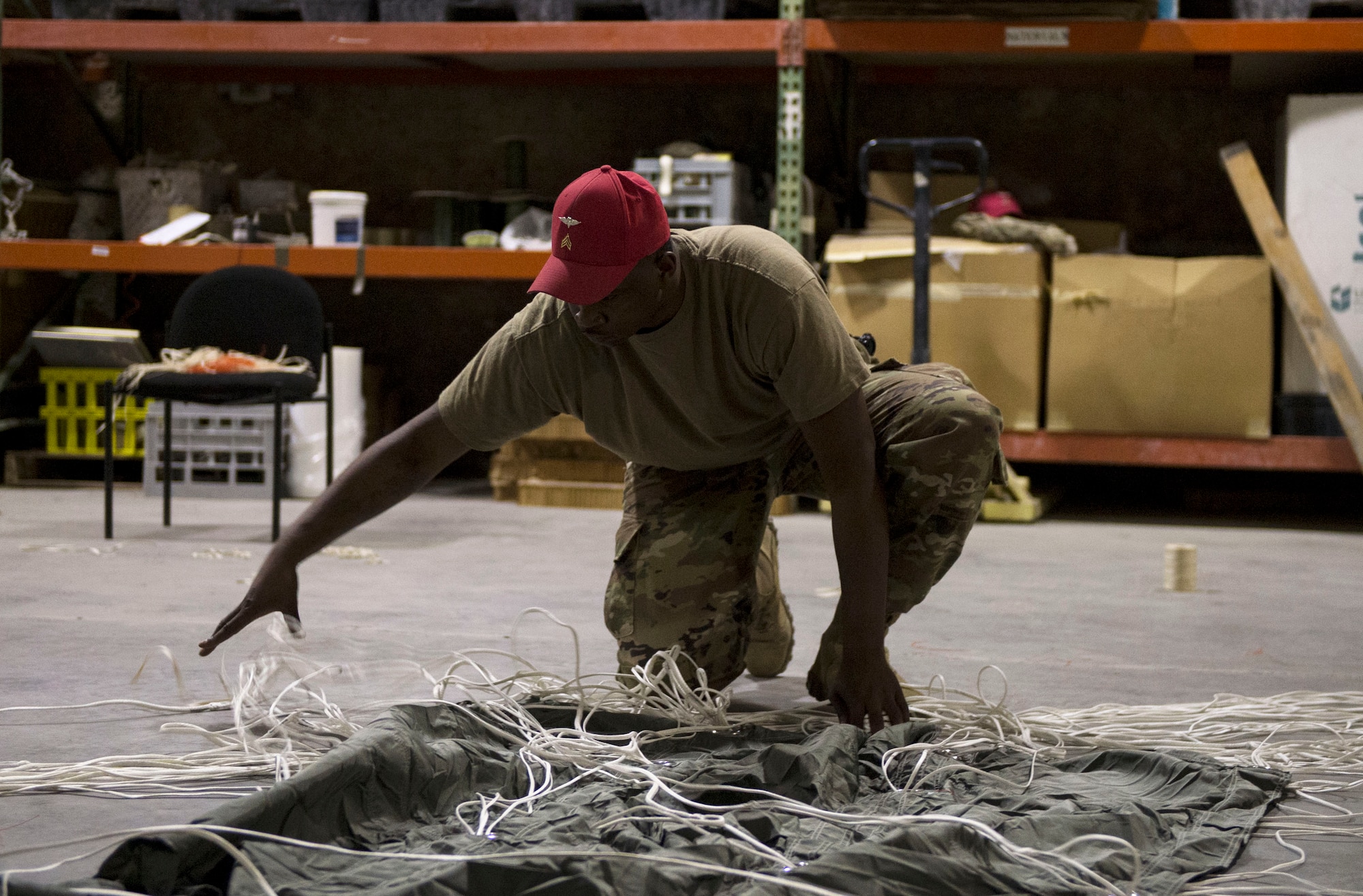 U.S. Army Sgt. Adrian Parks, a parachute rigger with the 824th Quartermaster Company Detachment 2, organizes the control lines at Al Udeid Air Base, Qatar, May 31, 2017. Parks organized the control lines for a joint precision airdrop system in order to conduct a full inspection on the system, designed for aircraft to drop cargo from a safe altitude, allowing them to be out of range of many anti-aircraft weapons systems. (U.S. Air Force photo by Tech. Sgt. Amy M. Lovgren)