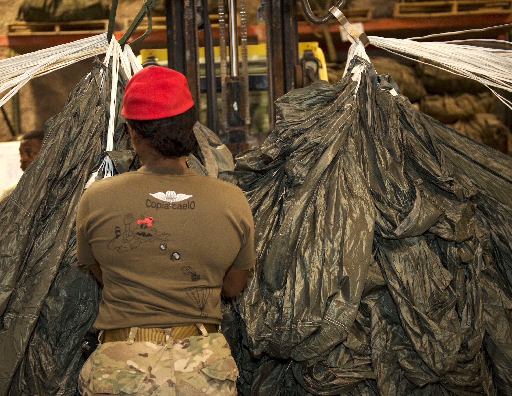 U.S. Army Spc. Elizabeth Watson, a parachute rigger with the 824th Quartermaster Company Detachment 2, inspects the main canopy of a joint precision airdrop system at Al Udeid Air Base, Qatar, May 31, 2017. The JPADS is designed for aircraft to drop cargo from a safe altitude, allowing them to be out of range of many anti-aircraft weapons systems. (U.S. Air Force photo by Tech. Sgt. Amy M. Lovgren)