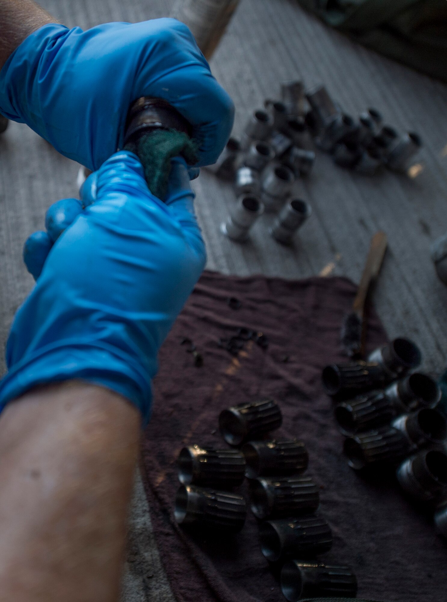 A munitions technician, assigned to the 23rd Expeditionary Aircraft Maintenance Unit, cleans ammunition parts before loading munitions on a B-52 Stratofortress assigned to the 23rd Expeditionary Bomb Squadron at an undisclosed location in Southwest Asia, June 15, 2017. The 23rd EAMU provided the 400th consecutive sortie without a maintenance cancellation on the day the 23rd EBS celebrated the 100th anniversary of the unit. (U.S. Air Force photo by Staff Sgt. Trevor T. McBride) 
