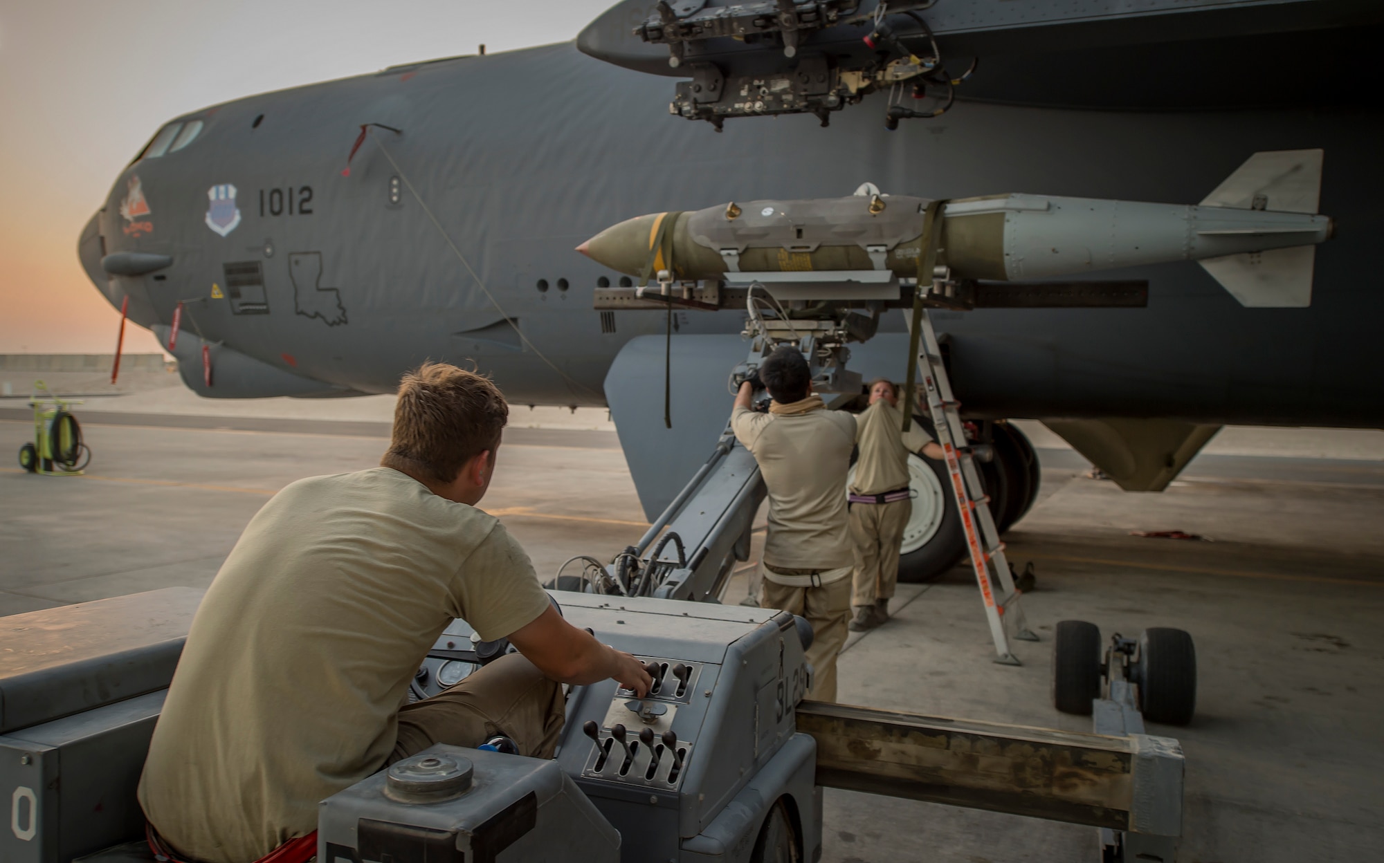 Three 23rd Expeditionary Aircraft Maintenance Unit munitions technicians load munitions on a B-52 Stratofortress at an undisclosed location in Southwest Asia, June 15, 2017. The 23rd EAMU provided the 400th consecutive sortie without a maintenance cancellation on the day the 23rd Expeditionary Bomb Squadron celebrated the 100th anniversary of the unit. (U.S. Air Force photo by Staff Sgt. Trevor T. McBride) 
