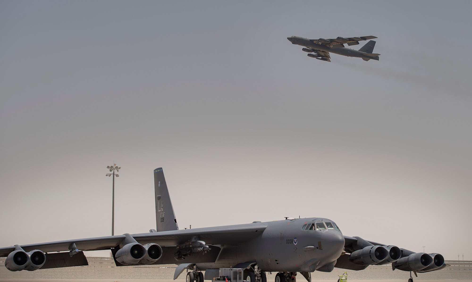 A B-52 Stratofortress lands while another takes off at an undisclosed location in Southwest Asia, June 16, 2017. Both B-52s are assigned to the 23rd Expeditionary Bomb Squadron, which celebrated its 100th anniversary today. (U.S. Air Force photo by Staff Sgt. Trevor T. McBride) 