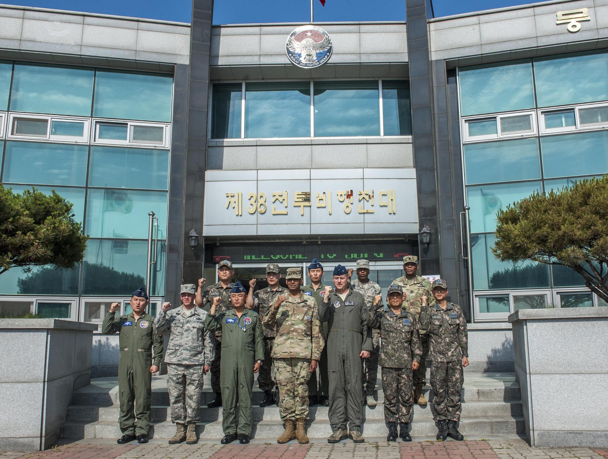 U.S. Army Gen. Vincent K. Brooks, United States Forces Korea commander, center, poses for a photo outside of the 38th Fighter Group Headquarters with members of the Wolf Pack and Republic of Korea Air Force at Kunsan Air Base, Republic of Korea, June 22, 2017. Brooks visited Kunsan Air Base to meet different squadrons which contribute to the mission capable forces he commands and familiarize himself with the base and its capabilities. (U.S. Air Force photo by Senior Airman Colville McFee/Released)