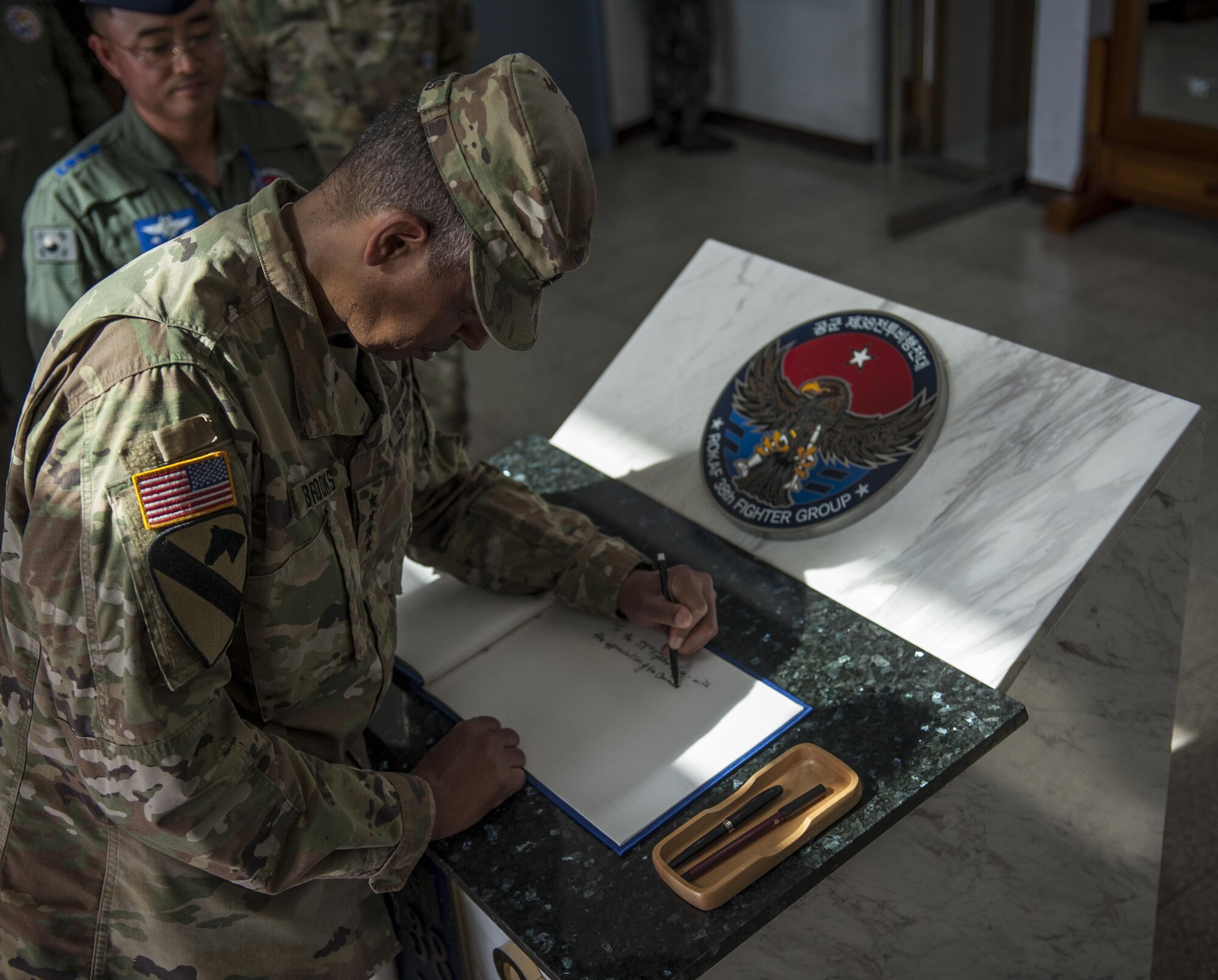 U.S. Army Gen. Vincent K. Brooks, U.S. Forces Korea commander, signs a guest book June 22, 2017, during a visit at Kunsan Air Base, Republic of Korea. Brooks visited Kunsan Air Base to discuss the operational and support capabilities the different squadrons provide to the USFK mission and familiarize himself with the base. (U.S. Air Force photo by Senior Airman Colville McFee/Released)