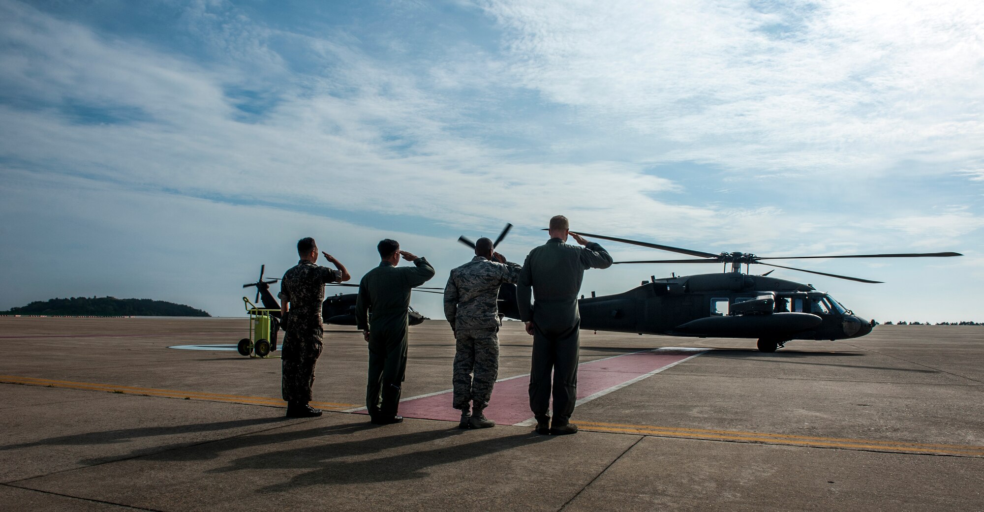 U.S. Air Force and Republic of Korea Air Force service leadership at Kunsan Air Base, Republic of Korea, render a salute as U.S. Army Gen. Vincent K. Brooks’s U.S. Army UH-60 prepares to depart the base June 22, 2017.  During his visit, Brooks toured multiple squadrons around the installation to familiarize himself with the capabilities which support the overall USFK mission and to recognize and talk with outstanding performers throughout the base. (U.S. Air Force photo by Senior Airman Colville McFee/Released)