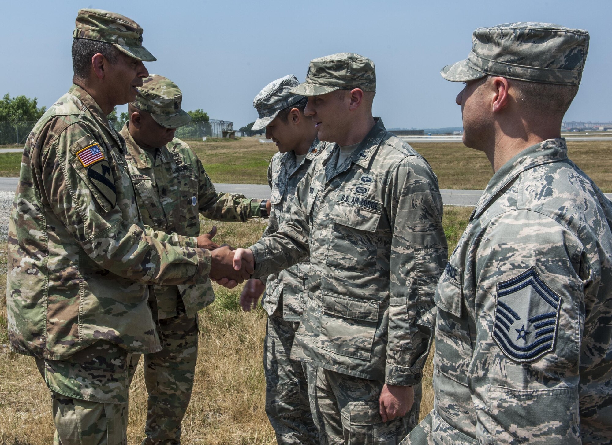 U.S. Army Gen. Vincent K. Brooks, United States Forces Korea commander, coins an Airman assigned to the 8th Operations Group, recognizing him as an outstanding performer at Kunsan Air Base, Republic of Korea, June 22, 2017. During his visit, Brooks recognized Airmen from multiple units for their hard work. (U.S. Air Force photo by Senior Airman Colville McFee/Released)