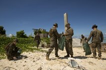 BETIO ISLAND, TARAWA ATOLL, KIRIBATI— Marines and Sailors with Task Force Koa Moana 17 pick up trash during a beach cleanup, June 16, 2017, on Betio Island, Tarawa Atoll, Kiribati. The cleanup took place during a week of training where Marines and Sailors trained and shared ideas with the Kiribati Police Maritime Unit to develop a more capable, well-rounded police force. (U.S. Marine Corps photo by Sgt. Douglas D. Simons)