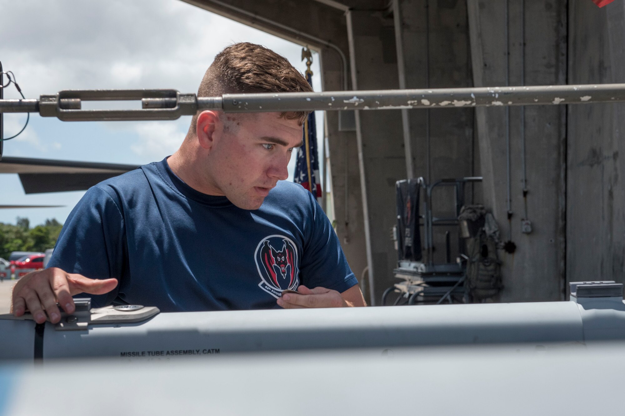 U.S. Air Force Senior Airman Jacob Clark, 44th Aircraft Maintenance Unit weapons load team crew member, inspects an AIM-9 sidewinder missile during a quarterly weapons load competition June 23, 2017, at Kadena Air Base, Japan. The competition was held between the 44th and 67th Aircraft Maintenance Units and the 120th Fighter Squadron, from Colorado Air National Guard, Buckley Air Force Base, for quickest and most accurate loading of weapons on their respective aircraft. (U.S. Air Force photo by Senior Airman John Linzmeier)