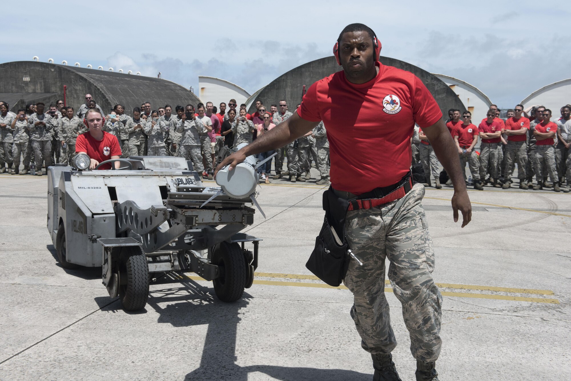 U.S. Air Force Airman 1st Class Justine Sunny and Staff Sgt. Jason Jones, 67th Aircraft Maintenance Unit weapons load team crew members, use an MJ-1C lift truck to transport an AIM-120 advanced medium range air-to-air missile to an F-15 Eagle fighter aircraft during a quarterly weapons load competition June 23, 2017, at Kadena Air Base, Japan. The Colorado Air National Guard Fighter Squadron, from Buckley Air Force Base, Colo., is touring Kadena as part of a theater security package.  (U.S. Air Force photo by Senior Airman John Linzmeier)