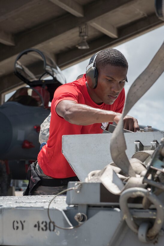 U.S. Air Force Senior Airman Deshawn Jemison, 67th Aircraft Maintenance Unit weapons load team crew member, inspects an AIM-9 sidewinder missile during a quarterly weapons load competition June 23, 2017, at Kadena Air Base, Japan. The competition was held between the 44th and 67th Aircraft Maintenance Units and the 120th Fighter Squadron, from Colorado Air National Guard, Buckley Air Force Base, for quickest and most accurate loading of weapons on their respective aircraft. (U.S. Air Force photo by Senior Airman John Linzmeier)