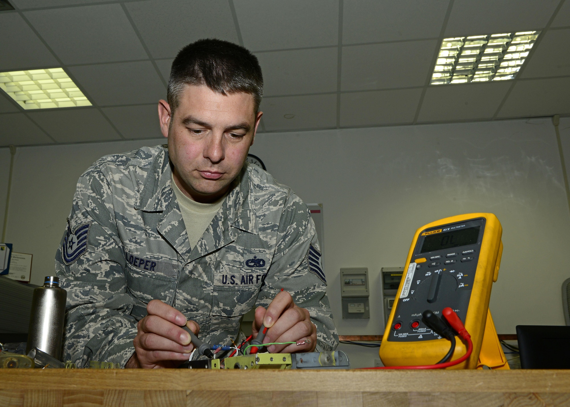 Tech. Sgt. Michael Loeper, 31st Maintenance Group Air Force Repair Enhancement Program wing manager, uses a digital multimeter to measure electrical properties of a component he is fixing, June 14, 2017 at Aviano Air Base, Italy. AFREP has repaired 125 items to this point during the 2017 fiscal year. (U.S. Air Force photo by Airman 1st Class Ryan Brooks)