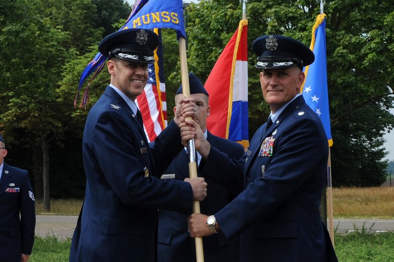 U.S. Air Force Col. Richard K. Bohn Jr., 52nd Munitions Maintenance Group commander, gives the ceremonial guidon to U.S. Air Force Lt. Col. Christopher Graves, 703rd Munitions Support Squadron commander, during the 703rd MUNSS change of command ceremony on Royal Netherlands Air Force, Vokel, the Netherlands, June 23, 2017. (U.S. Air Force photo by Master Sgt. Jonathan Mercado)