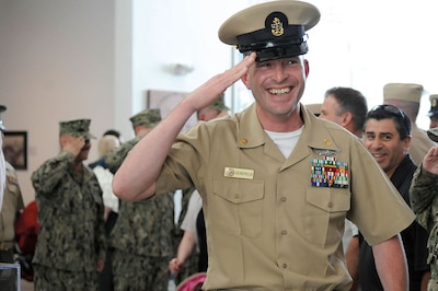 Chief Builder Keith Genereux, assigned to Naval Mobile Construction Battalion 5, renders final salute while passing through sideboys at his retirement ceremony, Port Hueneme, California, May 4, 2012 (U.S. Navy/Ace Rheaume)