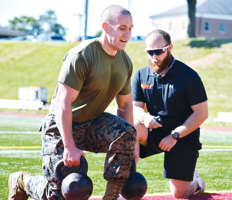 High Intensity Tactical Trainer Charles Yackle won't let Staff Sgt. Christopher Ramsey quit as he does kettlebell lunges in Butler Stadium.