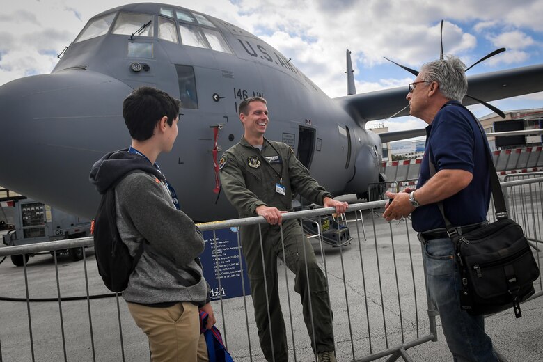 A C-130J Super Hercules loadmaster from Channel Islands, California, speaks to air show attendees at Le Bourget Airport, France, during the Paris Air Show, June 23, 2017. The Paris Air Show offers the U.S. a unique opportunity to showcase their leadership in aerospace technology to an international audience. By participating, the U.S. hopes to promote standardization and interoperability of equipment with their NATO allies and international partners. This year marks the 52nd Paris Air Show and the event features more than 100 aircraft from around the world. (U.S. Air Force photo/ Tech. Sgt. Ryan Crane)