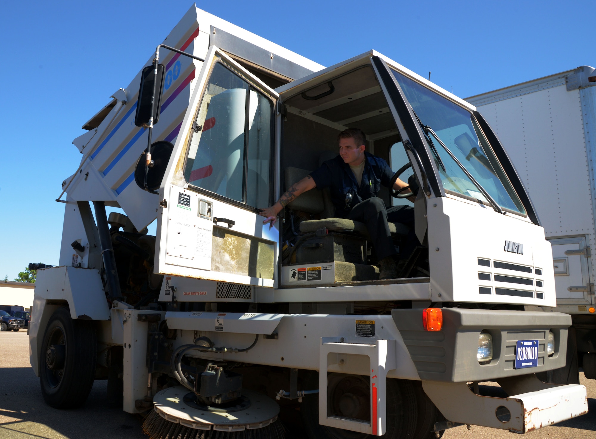 Senior Airman Dalton Dritz, 5th Logistics Readiness Squadron vehicle maintainer, lifts a street sweeper bed at Minot Air Force Base, N.D., June 19, 2017. The 5th LRS vehicle maintainers determine serviceability, overall condition of the vehicles, and need for repair through visual and audio examinations. (U.S. Air Force photo by Airman 1st Class Dillon J. Audit)
