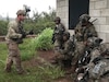 Army Reserve Soldiers of Echo Company, 100th Battalion, 442nd Infantry Regiment receive instruction from an Observer/Controller (OC) of the 196th Infantry Brigade (Training Support Brigade) during exercise Lava Forge, at Kahuku Training Area, Hawaii.