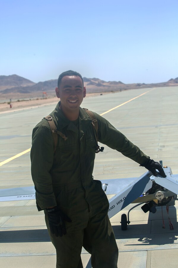 U.S. Marine Corps Lance Cpl. Miguel Salazar, an unmanned aerial vehicle technician with Marine Unmanned Aerial Vehicle Squadron 4, Marine Aircraft Group 41, 4th Marine Aircraft Wing, Marine Forces Reserve, poses in front of an RQ-7B Shadow at Camp Wilson, Marine Air Ground Combat Center, Twentynine Palms, California, June 22, 2017. Salazar was among Marines at VMU-4 who provided aerial reconnaissance in support of the 2nd Battalion, 25th Marine Regiment, 4th Marine Division, MARFORRES final battalion exercise of ITX 4-17. (U.S. Marine Corps photo by Lance Cpl. Imari J. Dubose)