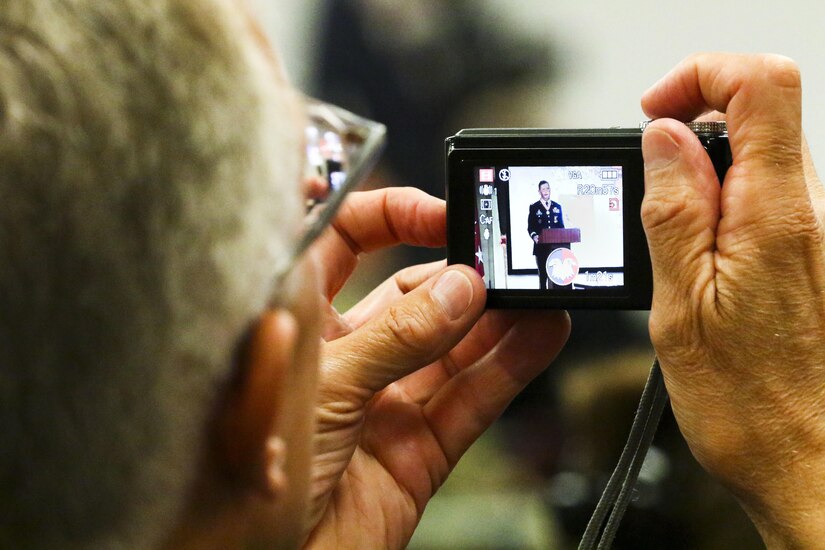 An audience member takes a photo of Maj. Gen. David Conboy during his retirement ceremony at Fort Bragg, NC, June 23, 2017. The ceremony honored Conboy for his impact on not only the Army Reserve, but the nation and its allies as well over a 33-year career. (U.S. Army photo by Staff Sgt. Felix R. Fimbres)