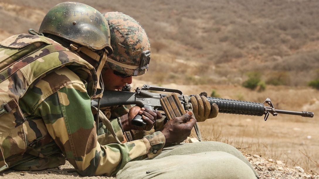 Cpl. Hayden Garrett, a rifleman with Special Purpose Marine Air-Ground Task Force – Crisis Response – Africa, coaches a soldier with Senegal’s 5th Contingent in Mali through remedial action of the M16A2 rifle during a peacekeeping operations training mission at Thies, Senegal, June 9, 2017. Marines and Sailors with SPMAGTF-CR-AF served as instructors and designed the training to enhance the commandos’ abilities to successfully deploy in support of United Nations peacekeeping missions in the continent. (U.S. Marine Corps photo by Sgt. Samuel Guerra/Released)