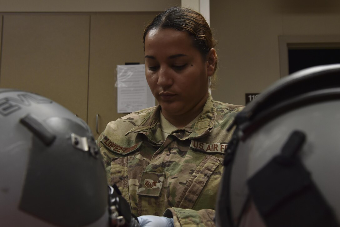 Staff Sgt. Carmen Lopez-Torres, an aircrew flight equipment technician with the 1st Special Operations Support Squadron, performs a 30-day visual inspection on aircrew helmets at Hurlburt Field, Fla., June 15, 2017. The 30-day visual inspection requires that AFE technicians examine the helmet and mask for any damage or missing components. (U.S. Air Force photo by Airman 1st Class Rachel Yates)