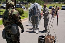 U.S. Air Force Reserve Master Sgt. Ronald Johnson, aircrew flight equipment supervisor, 913th Operations Support Squadron, directs aircrew members to the first station of an Aircrew Contamination Control Area (ACCA) during a training simulation June 19, 2017, at Little Rock Air Force Base, Ark. The purpose of an ACCA is to establish a location to provide detection, contamination control, and processing provisions for aircrew members into a toxic free environment. (U.S. Air Force photo by Master Sgt. Jeff Walston/Released)