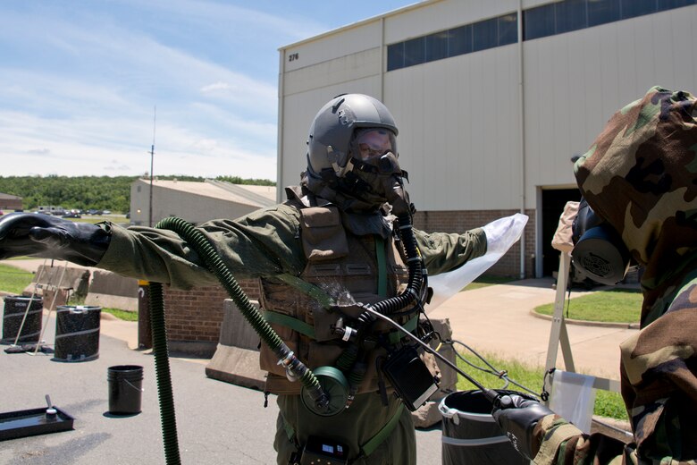 U.S. Air Force Reserve Staff Sgt. Michael Richardson, aircrew flight equipment (AFE) specialist, 913th Operations Support Squadron, sprays a simulated 5% chlorine solution on Staff Sgt. Michael Hopson, loadmaster, 327th Airlift Squadron, in the Aircrew Contamination Control Area (ACCA) June 19, 2017, at Little Rock Air Force Base, Ark. AFE members were conducting decontamination training for aircrew members to remove contaminants such as micro-organisms, hazardous materials or radioactive substances. (U.S. Air Force photo by Master Sgt. Jeff Walston/Released)