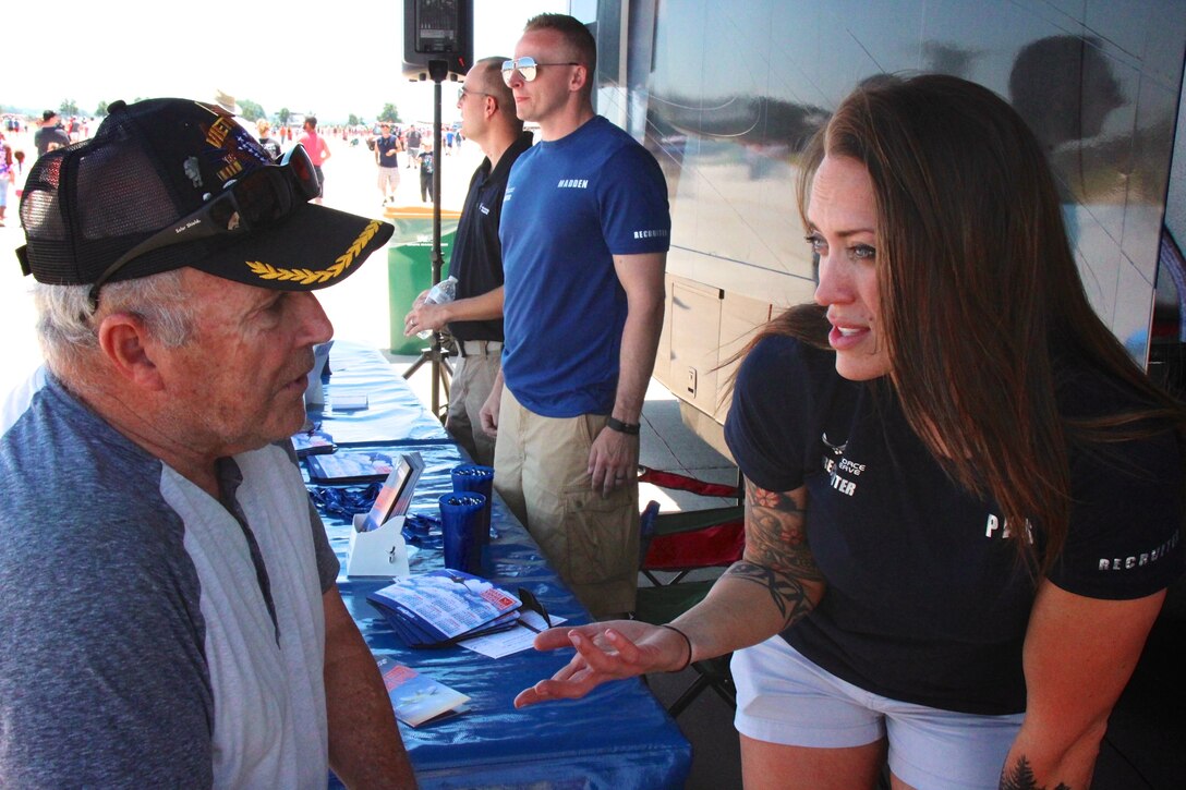 Representing the wing at t far right, Tech. Sgt. Brittany Paus, 932nd Airlift Wing recruiter, thanks a Vietnam veteran for his service to America, and explains the current Air Force Reserve system on June 11, 2017.  Several unit recruiters and operations members told their particular stories about unique jobs to the public at the 2017 Air Show at Scott Air Force Base, Illinois.  The 932nd AW is a unit under 22nd Air Force.  (U.S. Air Force photo by Lt. Col. Stan Paregien)