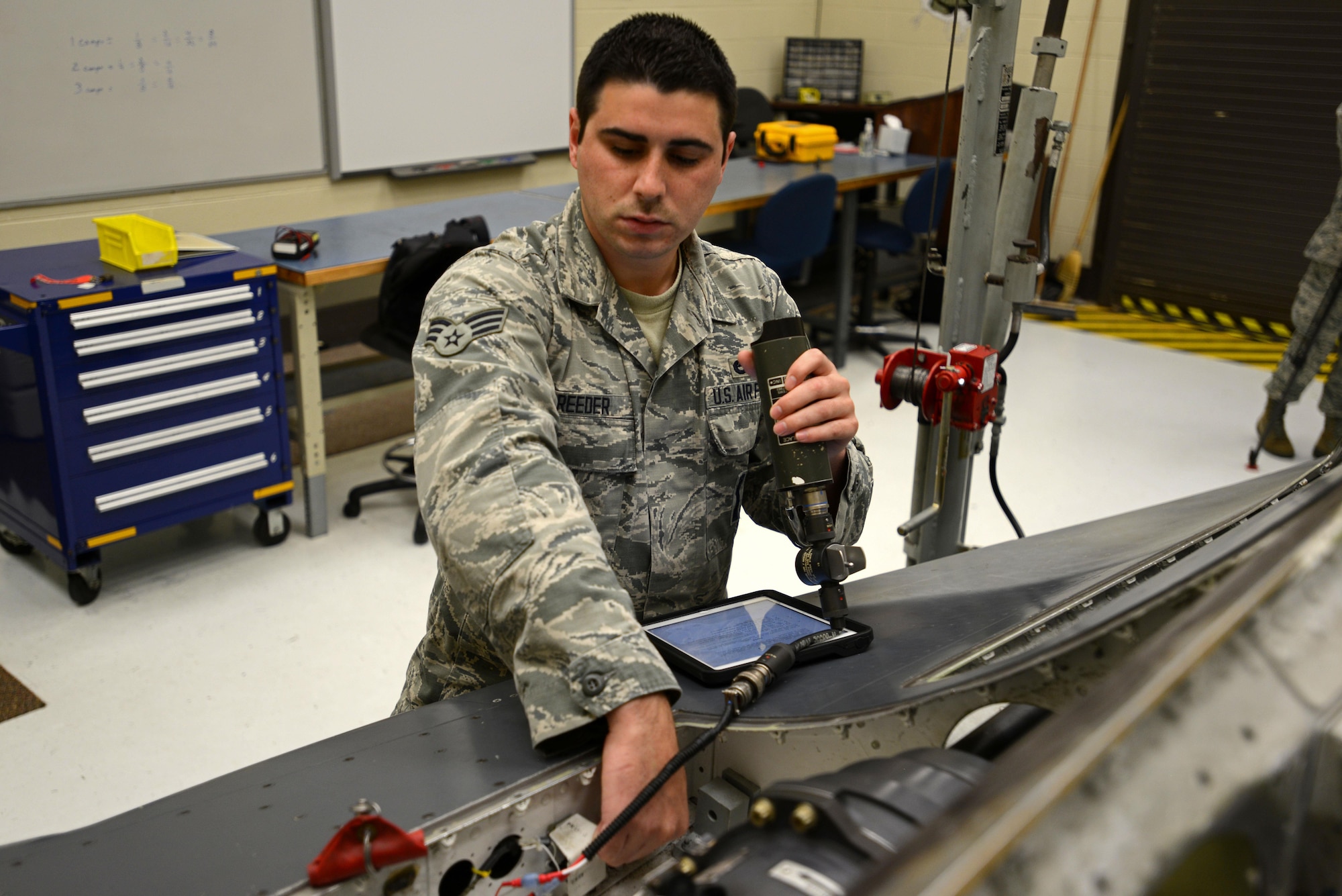 U.S. Air Force Senior Airman Collin Reeder, weapons standardization technician assigned to the 96th Maintenance Group at Eglin Air Force Base, Fla., assists in a gun hydraulic bleed and leak test on a mock F-16CM Fighting Falcon body during training at the 372nd Training Squadron, Detachment 202 F-16 Field Training Detachment (FTD) at Shaw Air Force Base, S.C., April 25, 2017.  Reeder spent approximately three weeks at Shaw to attend the advanced aircraft equipment and munitions training offered by the FTD. (U.S. Air Force photo by Senior Airman Kelsey Tucker)