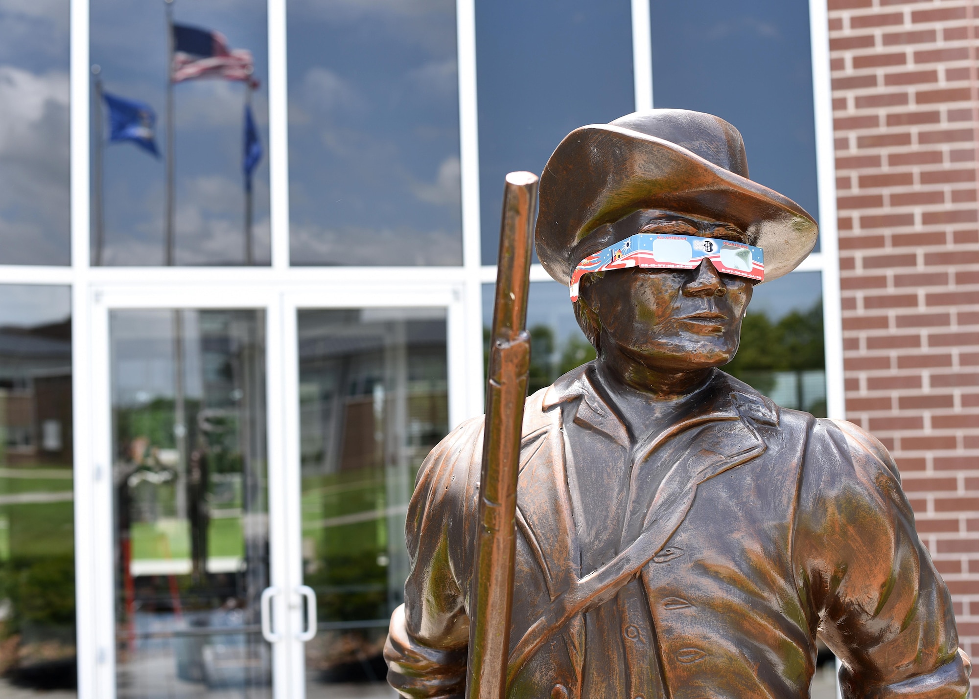 The Minuteman statue outside Patriot Hall at the Air National Guard’s I.G. Brown Training and Education Center dons a pair of eclipse glasses, June 22, 2017, to emphasize the need for safe viewing of the coming solar eclipse. The training center as well as the rest of McGhee Tyson Air National Guard Base in Louisville, Tenn., is within the path of totality during the event, Monday, August 21, 2017. (U.S. Air National Guard photo by Master Sgt. Mike R. Smith)